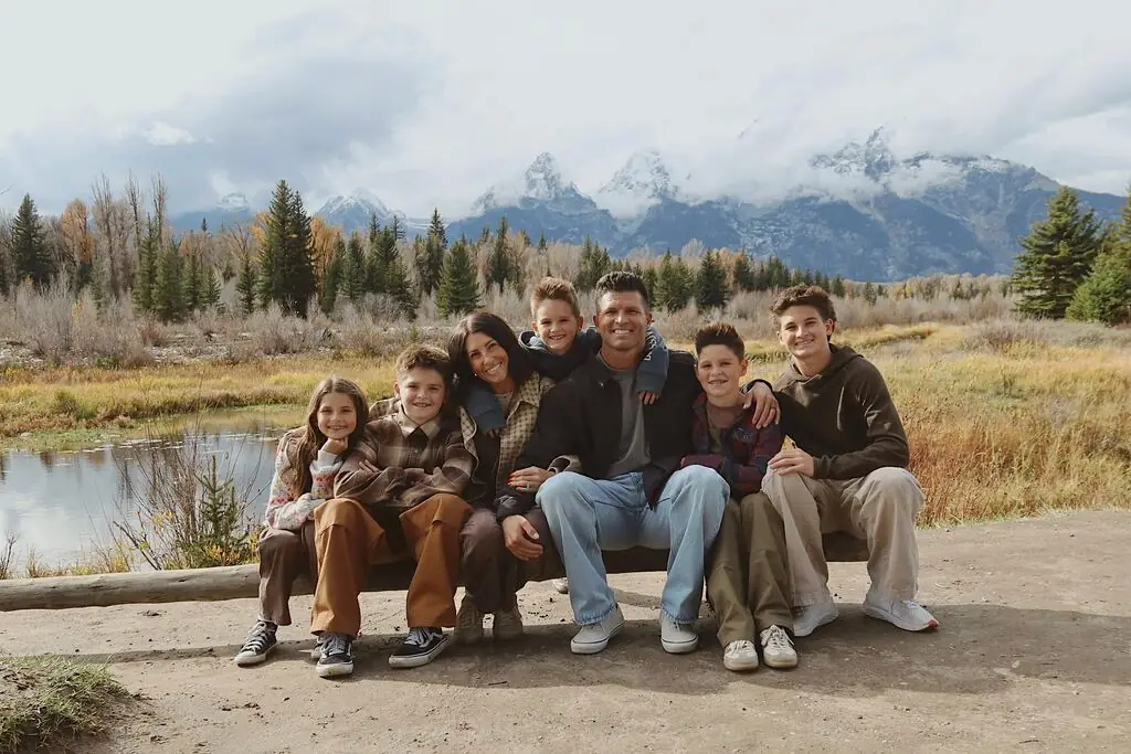 Colby Stringham with his wife and their five kids in front of the Teton mountains